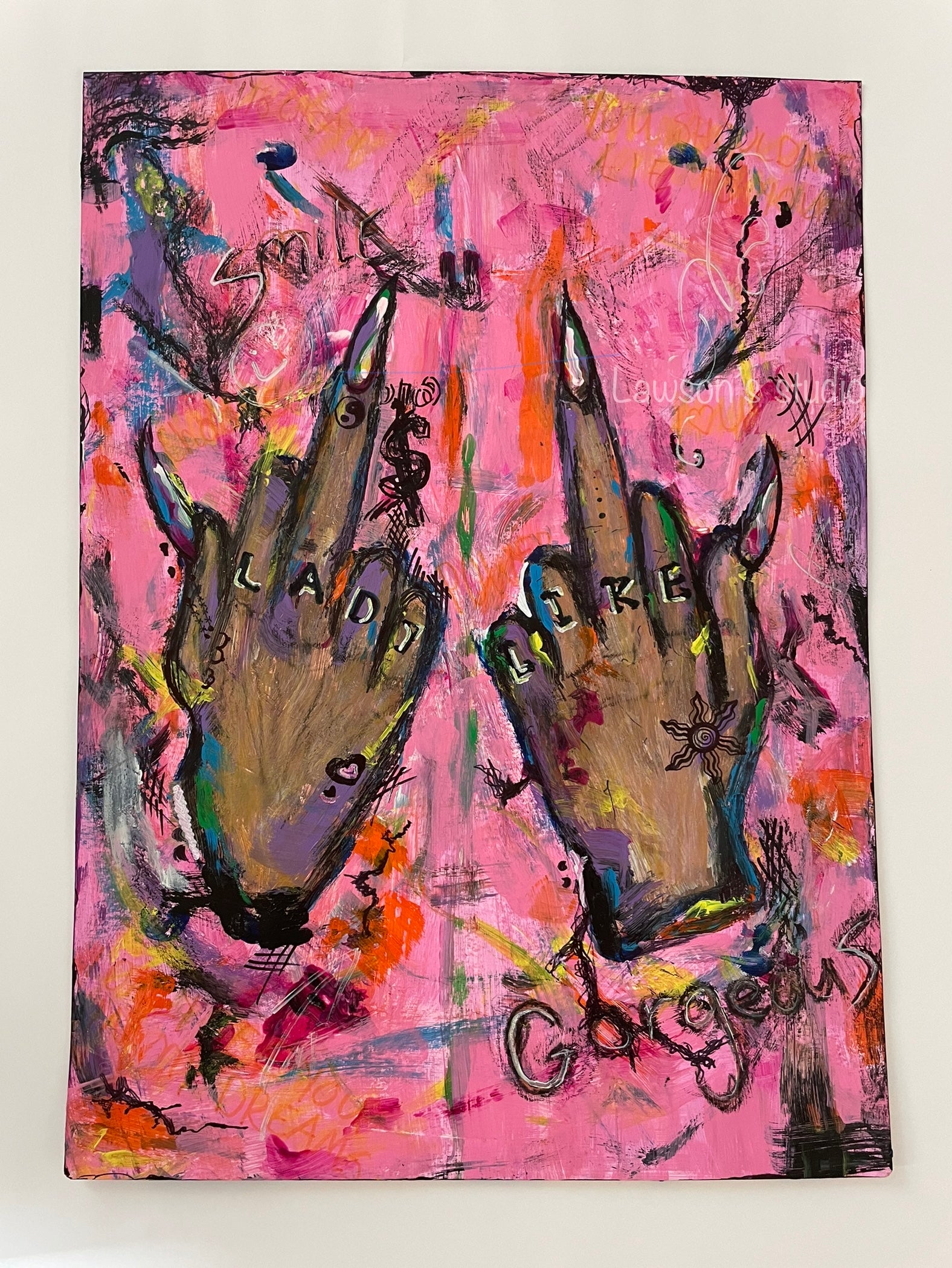 "Unapologetically bold, 'Lady like' features two hands meeting in a striking portrayal of individuality. This A3 acrylic and marker artwork boldly showcases a raised middle finger with 'lady like' knuckle tattoos against a vibrant pink background. Raw street art energy meets feminine allure in this fearless statement piece, exclusively from Lawson's Studio