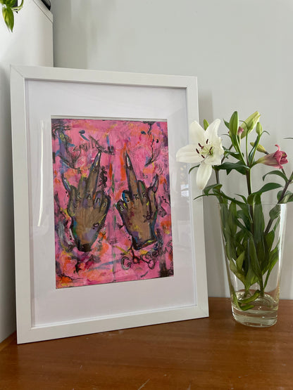 . Against a vibrant pink backdrop, the contrast of the daring gesture against the feminine hue intensifies the piece's impact.