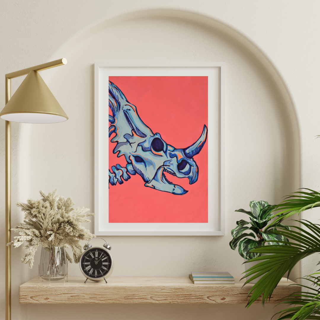 "Vibrant A3 artwork: Triceratops skull on a bold hot pink backdrop, highlighted with cool blue bones and subtle orange tones. Versatile décor for any room