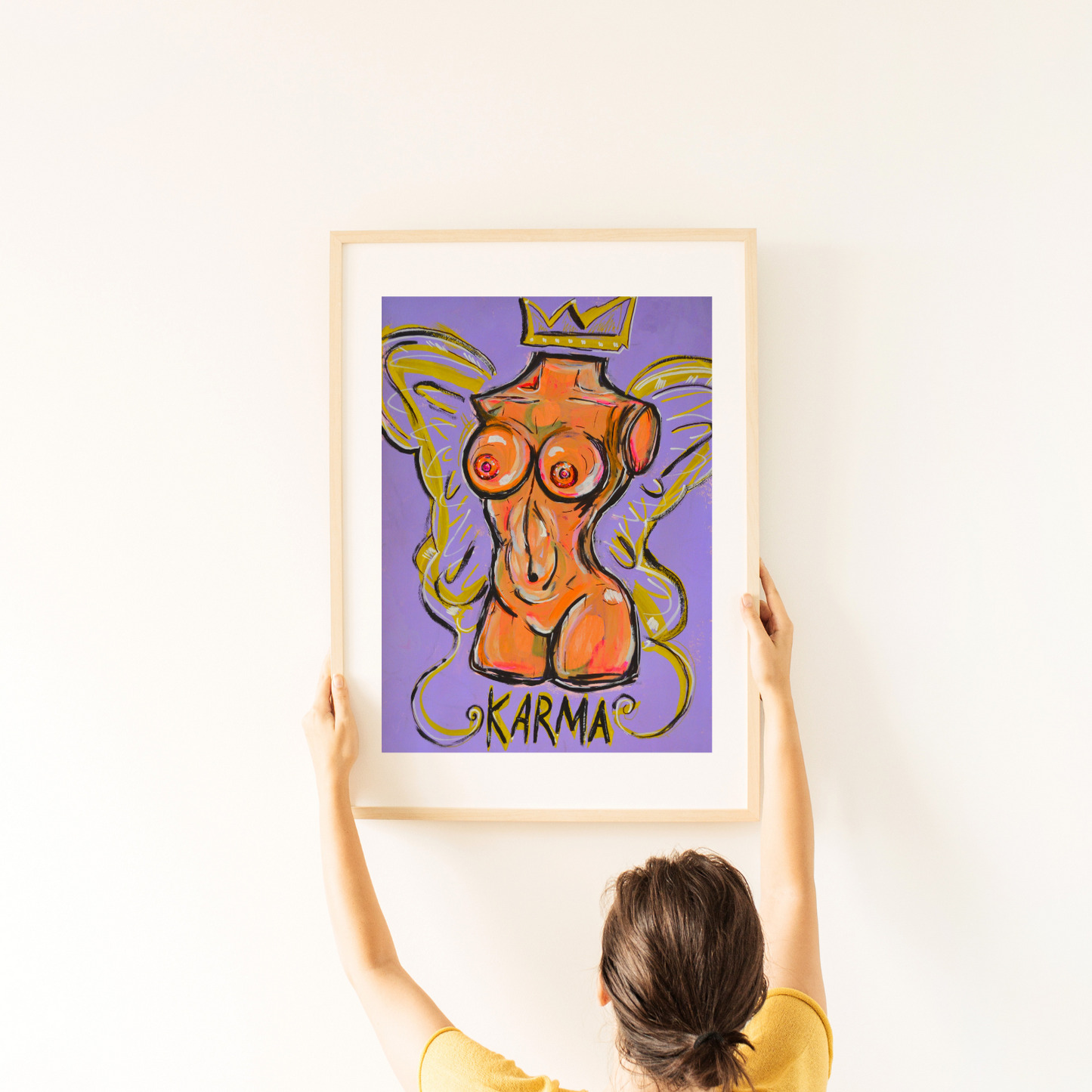 Vivid nude torso art in light orange, purple, and pink tones, adorned with gold details, framed in light wood, striking against a white wall—'Karma' blends urban edge with contemporary elegance